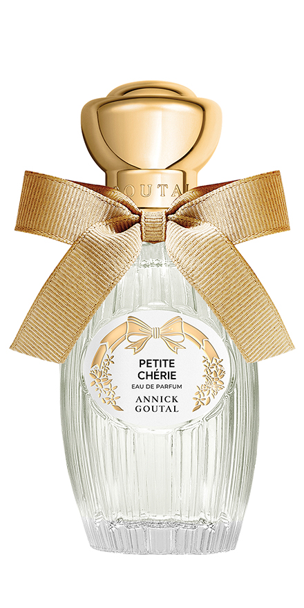 goutal-nobilis-group-packshots-880x440-PETITE-CHÉRIE - BERGERAT | WE MAKE BEAUTY PERFORM Glass perfume bottle with a gold cap and a large beige ribbon tied in a bow; label reads Petite Chérie Eau de Parfum by Annick Goutal